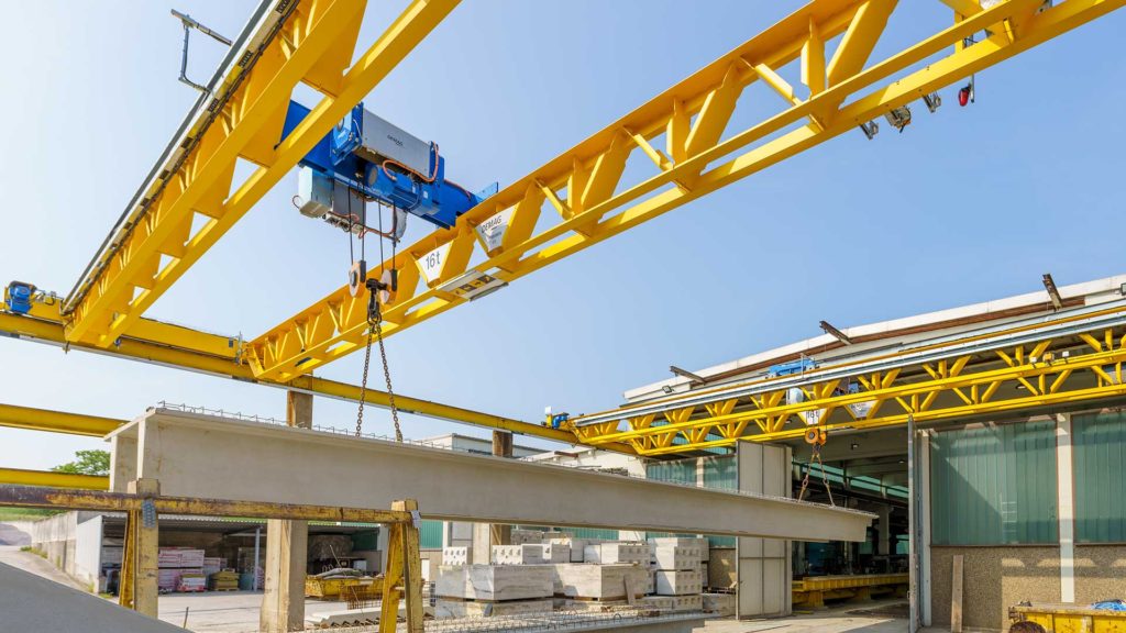 Demag DMR wire rope hoist on double v-girder cranes in an outdoor application.