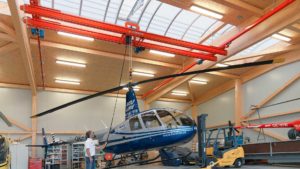 Demag DC chain hoist and KBK modular crane lifting a helicopter