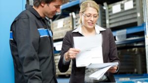 Crane service technician reviewing manuals with the crane owner