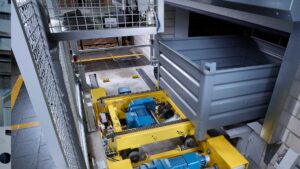 A bin loading onto the carousel of an automated storage and retrieval system (AS/RS).